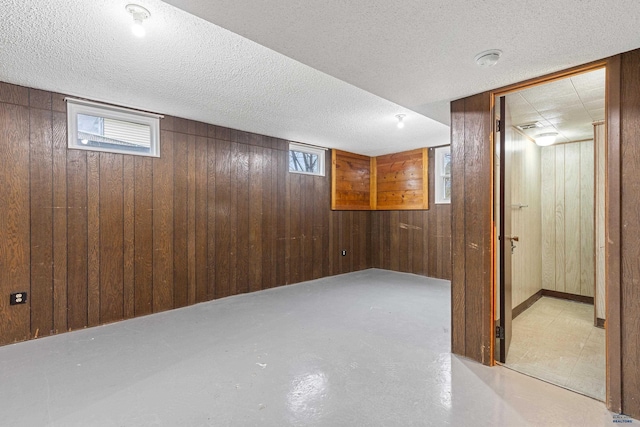 1937 Hillsview Dr, Rapid City, SD 57702 - below grade area with wooden walls, a textured ceiling, and a healthy amount of sunlight