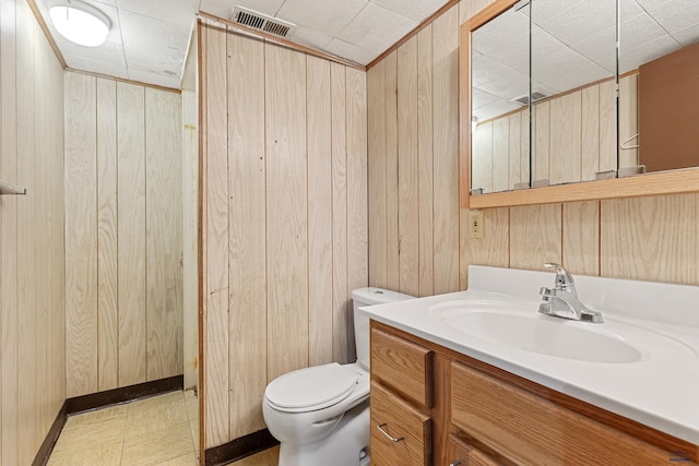 1937 Hillsview Dr, Rapid City, SD 57702 - bathroom with visible vents, toilet, wooden walls, and vanity