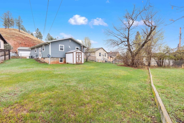 1937 Hillsview Dr, Rapid City, SD 57702 - view of yard with an outbuilding, entry steps, a shed, and a fenced backyard