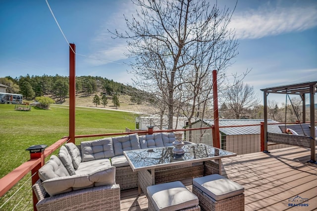 wooden deck featuring outdoor dining space, a yard, and an outdoor living space