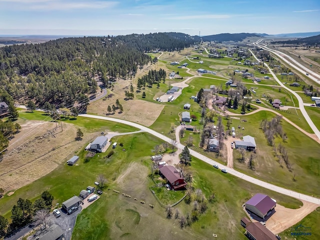birds eye view of property featuring a wooded view