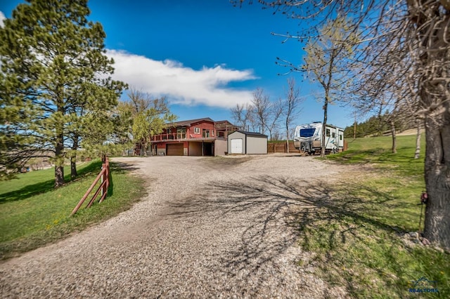 view of road with gravel driveway