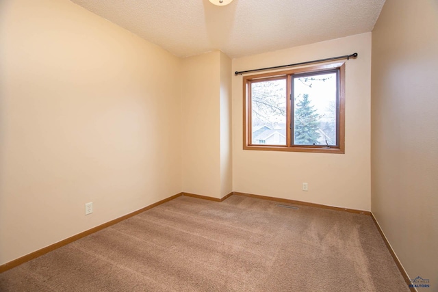 4028 Prairie View Dr, Rapid City, SD 57701 - unfurnished room featuring baseboards, a textured ceiling, and carpet