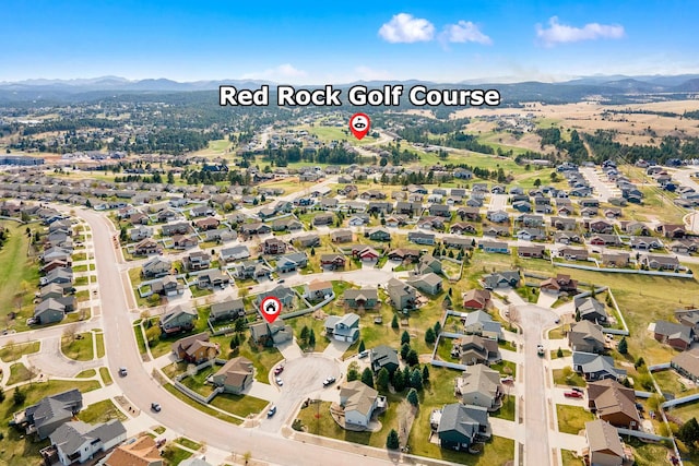 drone / aerial view featuring a residential view and a mountain view