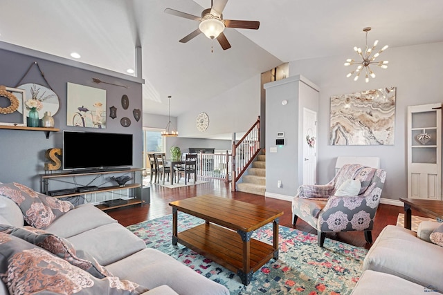 living area with recessed lighting, wood finished floors, ceiling fan with notable chandelier, baseboards, and stairway