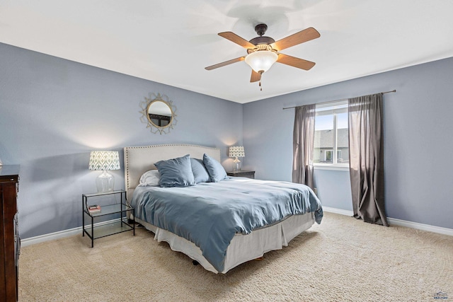 carpeted bedroom with ceiling fan and baseboards