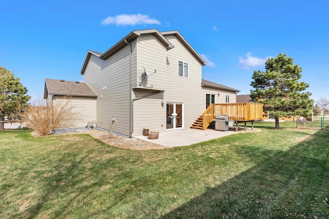 back of property featuring a patio, a wooden deck, and a yard