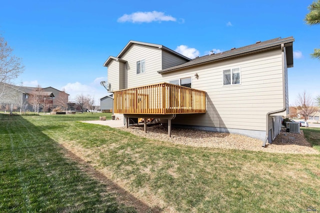 rear view of property featuring cooling unit, a lawn, and a deck