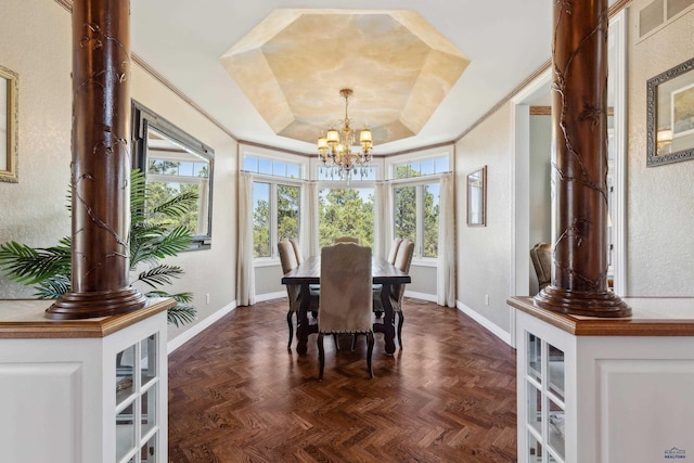 dining room featuring visible vents, a textured wall, baseboards, a raised ceiling, and a notable chandelier