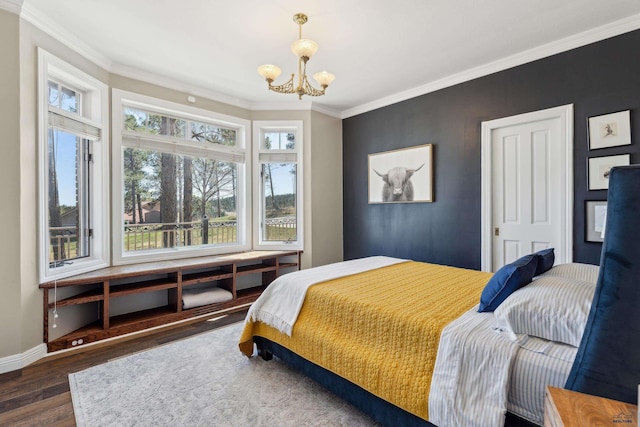 bedroom featuring crown molding, wood finished floors, a notable chandelier, and multiple windows