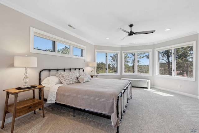 bedroom with visible vents, crown molding, baseboards, a ceiling fan, and carpet