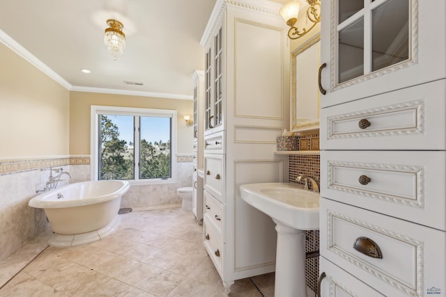 full bathroom with visible vents, crown molding, tile walls, a wainscoted wall, and a soaking tub