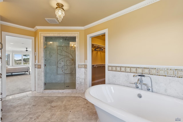 full bath with a walk in closet, visible vents, crown molding, a shower stall, and a soaking tub