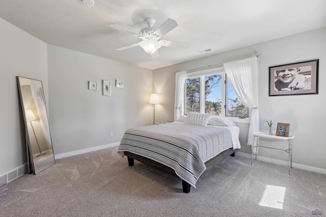 carpeted bedroom featuring a ceiling fan, baseboards, and visible vents