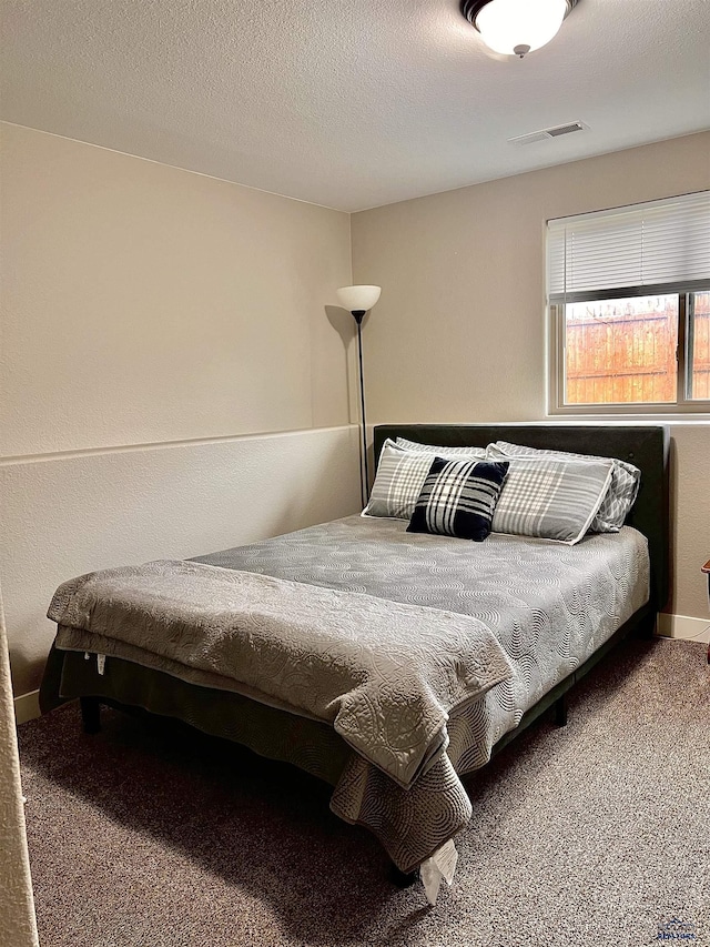 bedroom featuring carpet flooring and visible vents