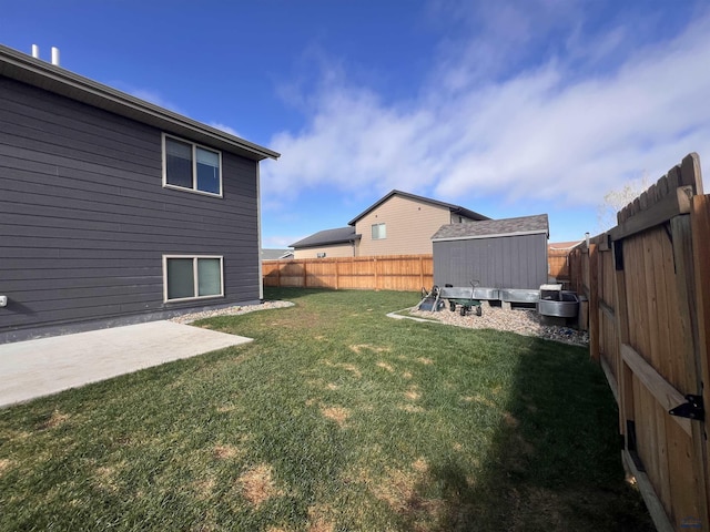 view of yard with an outdoor structure, a fenced backyard, a storage shed, and a patio