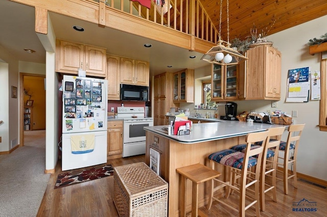 20842 Legacy, Sturgis, SD 57785 - kitchen with a peninsula, white appliances, glass insert cabinets, baseboards, and a kitchen bar