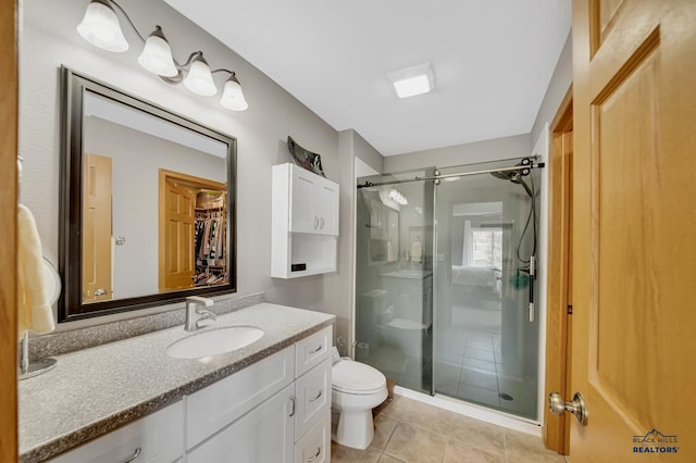 full bath with vanity, toilet, tile patterned flooring, and a stall shower