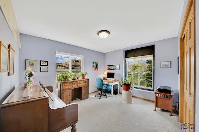 home office featuring light colored carpet and baseboards