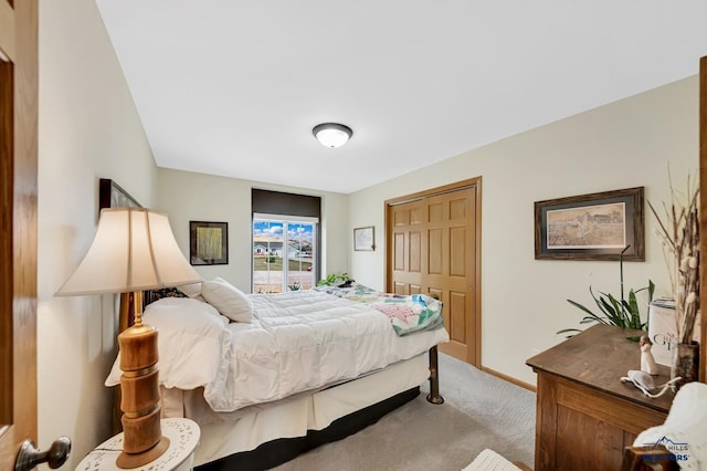 carpeted bedroom with baseboards and a closet