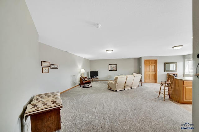 living room with baseboards and light colored carpet