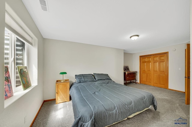 bedroom with baseboards and visible vents