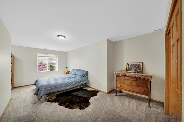 bedroom featuring baseboards, carpet, and visible vents