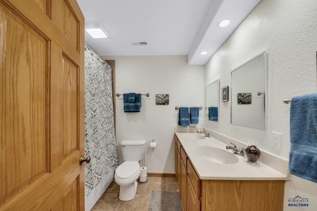 bathroom with a sink, tile patterned floors, toilet, and visible vents