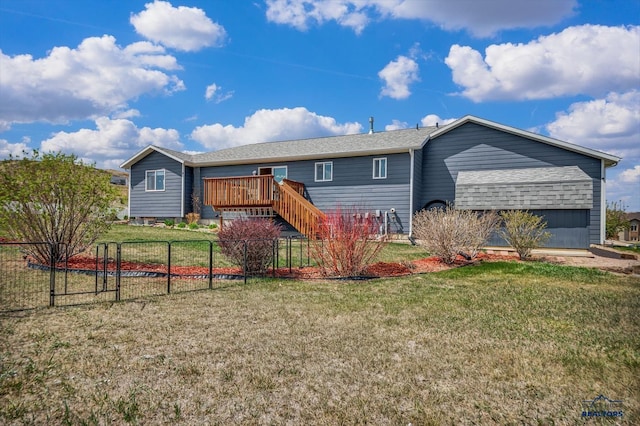 view of front facade with fence, a wooden deck, stairs, and a front lawn