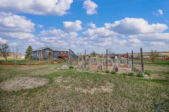 view of jungle gym featuring a yard and a vegetable garden