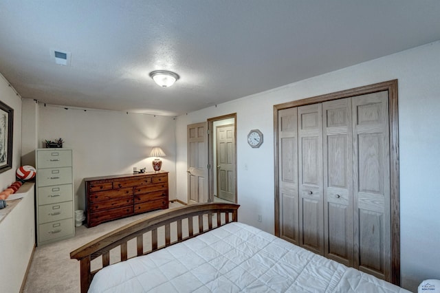 222 E Bengal Dr, Rapid City, SD 57701 - bedroom featuring carpet floors, a closet, a textured ceiling, and visible vents