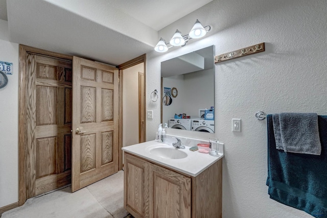 222 E Bengal Dr, Rapid City, SD 57701 - bathroom featuring independent washer and dryer, a textured wall, and vanity