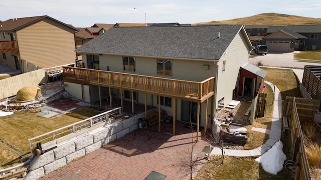 222 E Bengal Dr, Rapid City, SD 57701 - back of house featuring a deck with mountain view, a fenced backyard, and roof with shingles