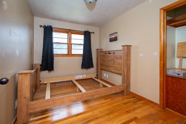 unfurnished bedroom with baseboards and wood finished floors