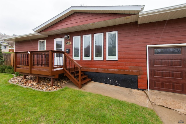 rear view of house featuring a yard and a wooden deck