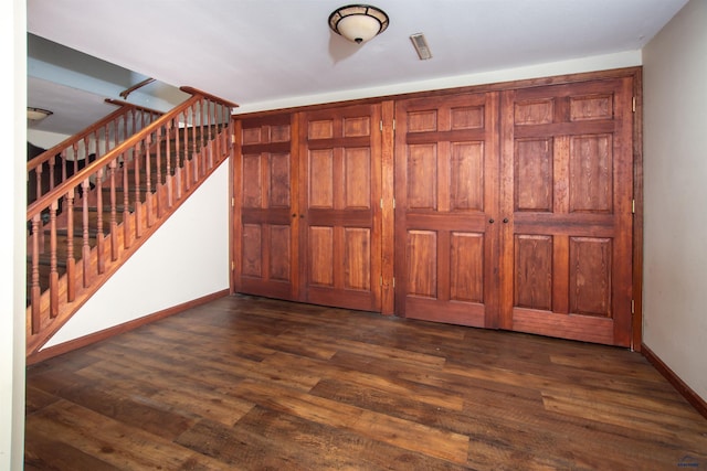 entrance foyer featuring stairs, baseboards, and dark wood finished floors