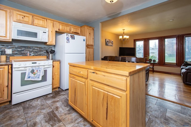 kitchen featuring white appliances, a chandelier, open floor plan, tasteful backsplash, and butcher block counters