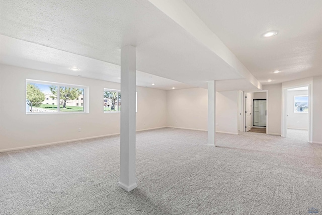 below grade area with recessed lighting, baseboards, and light colored carpet