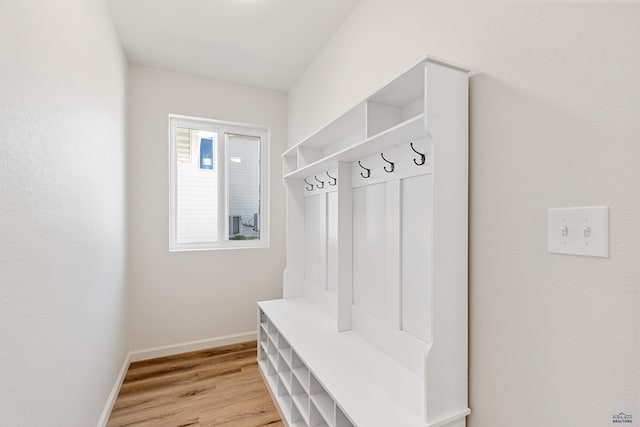 mudroom with baseboards and light wood finished floors