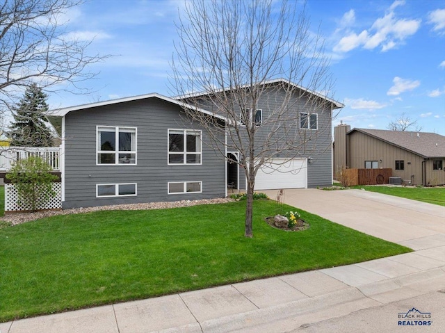 127 Union St, Spearfish, SD 57783 - split level home with an attached garage, a front lawn, and concrete driveway