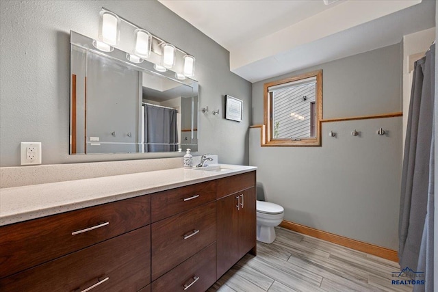 127 Union St, Spearfish, SD 57783 - full bathroom featuring vanity, toilet, a shower with shower curtain, baseboards, and wood finished floors