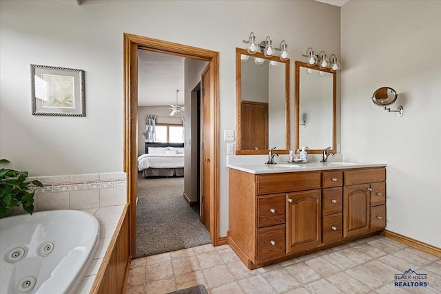 127 Union St, Spearfish, SD 57783 - ensuite bathroom with double vanity, ensuite bathroom, baseboards, a tub with jets, and a sink