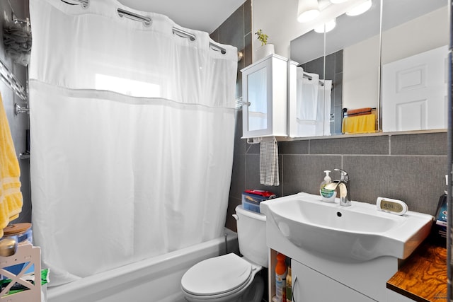bathroom featuring tile walls, vanity, toilet, and shower / bath combination with curtain