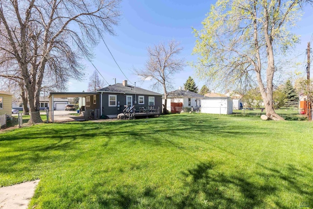 exterior space with a fenced backyard, a deck, and a carport