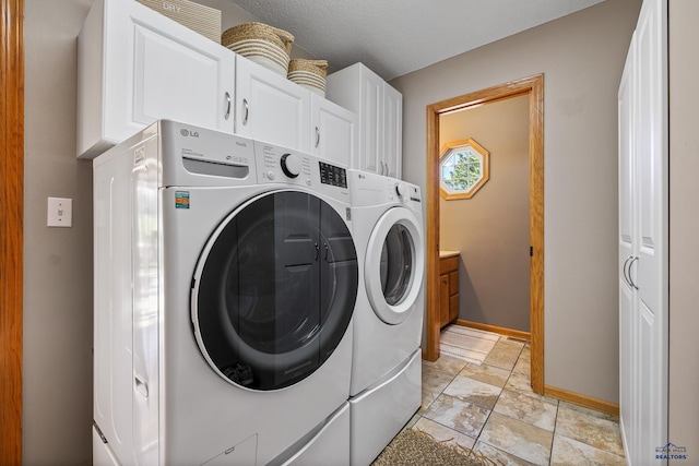 5201 Cale Ct, Rapid City, SD 57701 - clothes washing area featuring baseboards, cabinet space, stone finish floor, and independent washer and dryer