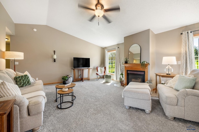 5201 Cale Ct, Rapid City, SD 57701 - living area featuring carpet floors, a glass covered fireplace, baseboards, a ceiling fan, and vaulted ceiling