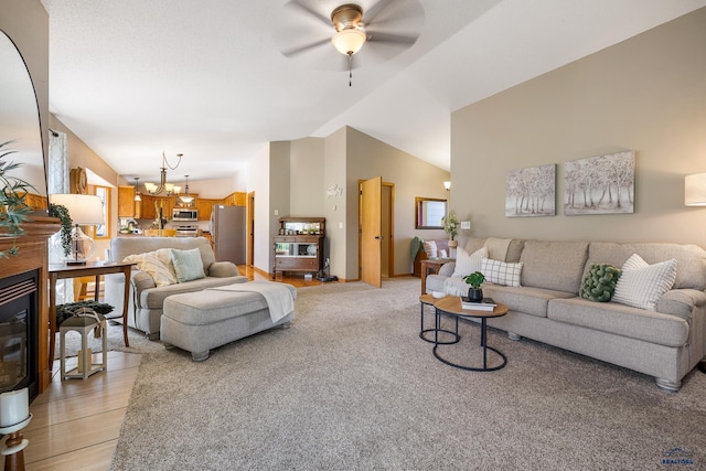 5201 Cale Ct, Rapid City, SD 57701 - living room featuring vaulted ceiling, ceiling fan with notable chandelier, and light wood-style flooring