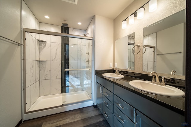1241 Kenai Dr, Box Elder, SD 57719 - bathroom featuring double vanity, a shower stall, a sink, and wood finished floors