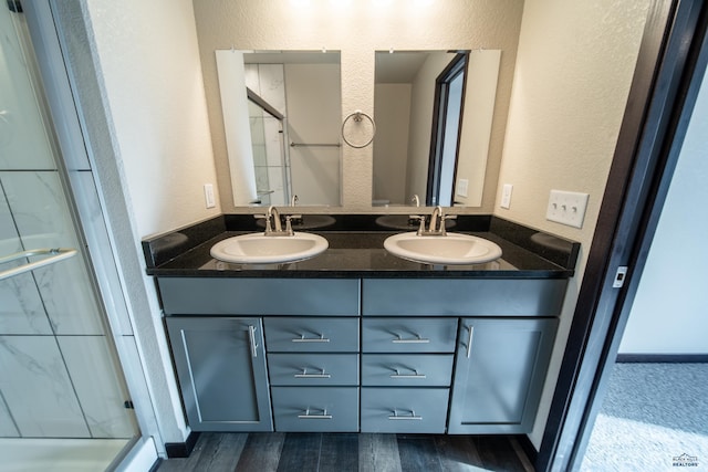 1241 Kenai Dr, Box Elder, SD 57719 - full bathroom featuring double vanity, a sink, and a shower stall