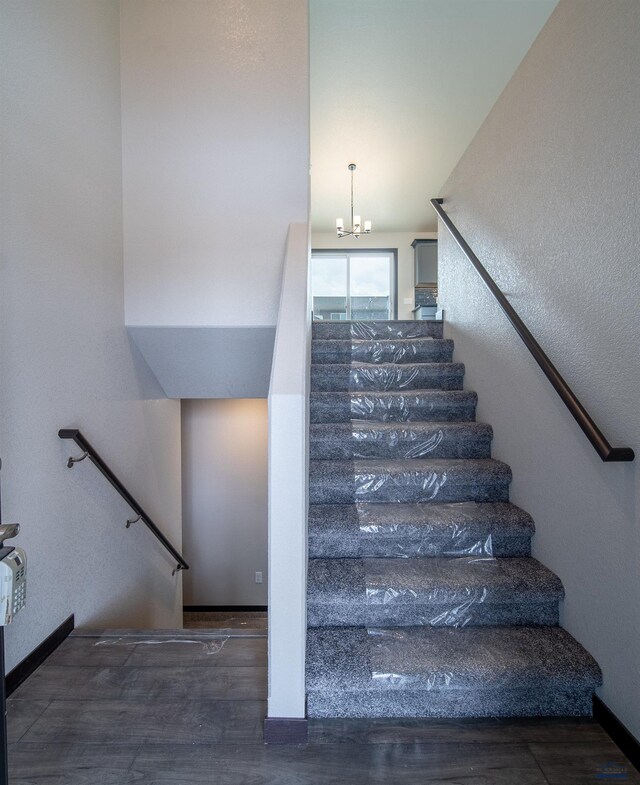 1241 Kenai Dr, Box Elder, SD 57719 - stairway with an inviting chandelier and wood finished floors